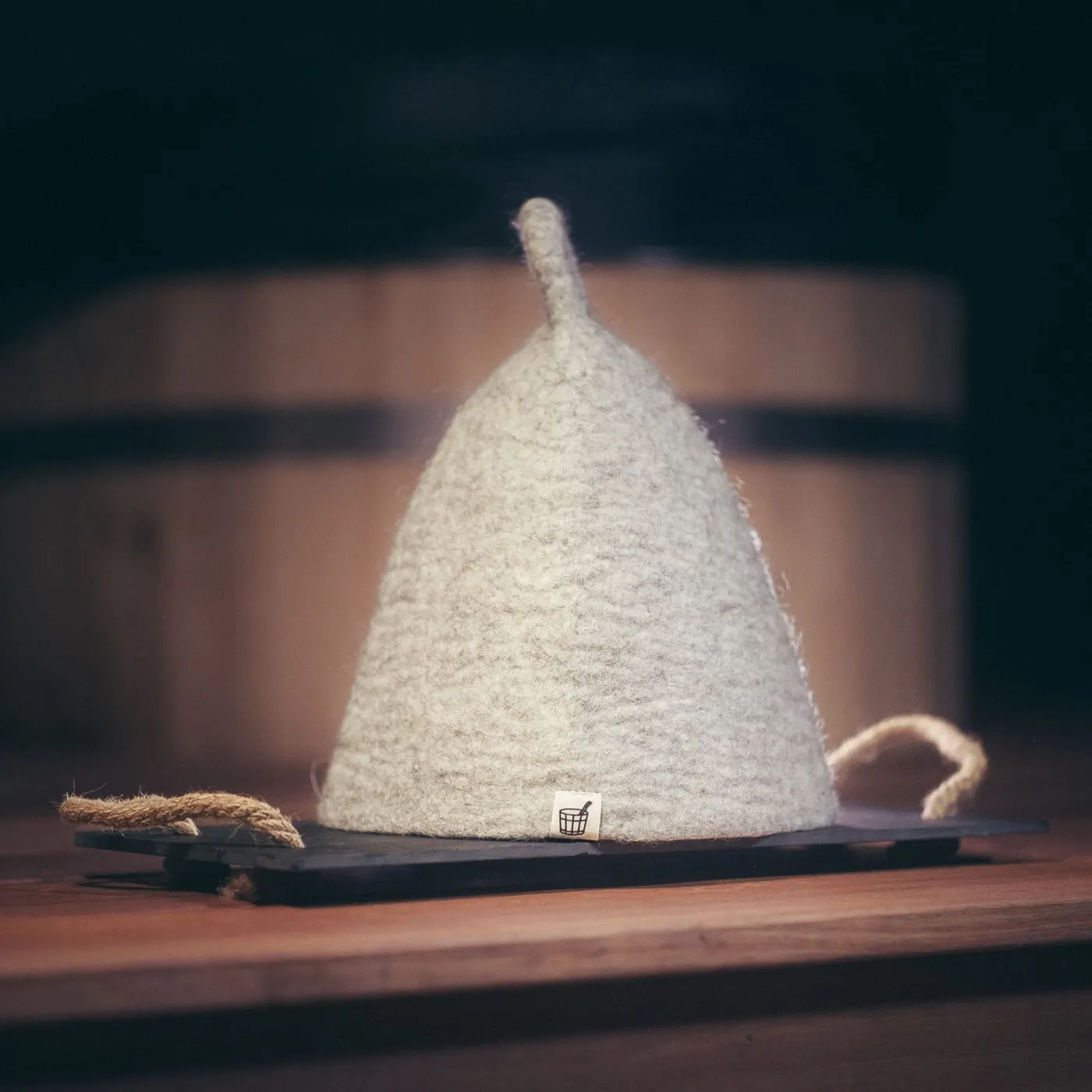 The Sauna Hat in Nordic Birch wool felt on a wooden board